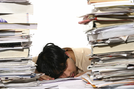 man overloaded with paperwork